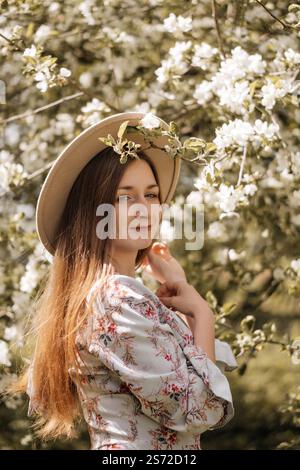 Blossoming Beauty: Woman in Floral Dress Among Spring Blooms Stock Photo