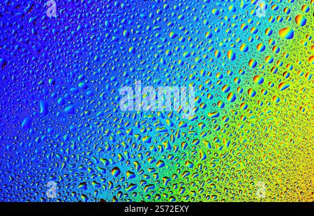 Vibrant droplets of water create a colorful abstract masterpiece on glass surface Stock Photo