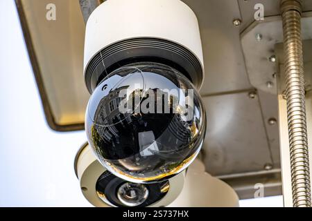 A camera is mounted on a pole and is looking down. The camera is black and white Stock Photo