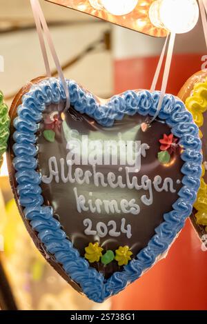 A heart-shaped cookie with the words 'Allerheiligen Kimes Soest 2024' written on it Stock Photo