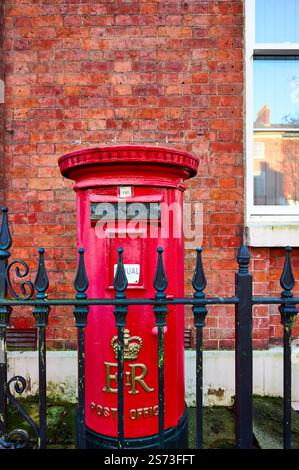 Red post box behind fence in the front garden of a house in Preston,UK ...