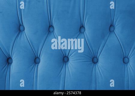 Capitone, diamond checkered soft fabric textile decorative background with buttons. Classic retro Chesterfield style, luxurious upholstery blue textur Stock Photo