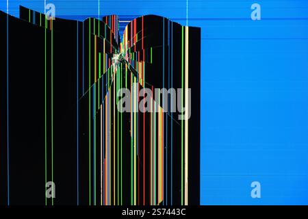 A broken screen with colorful vertical lines and digital artifacts on a blue background. An abstract image of destruction and technological malfunctio Stock Photo
