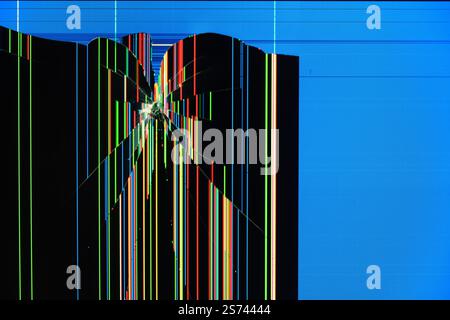 A broken screen with colorful vertical lines and digital artifacts on a blue background. An abstract image of destruction and technological malfunctio Stock Photo