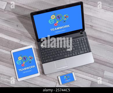 Teamwork concept shown on different information technology devices Stock Photo