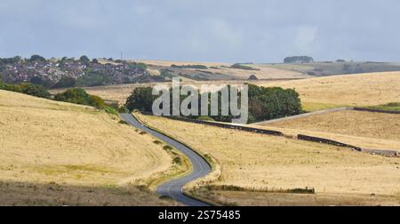 English country road with a town in the distance. Seaford, England, United Kingdom Stock Photo