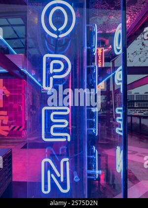 Neon open sign on the clear facade of The Rice Box, pink and blue lights, Rice Village District, Houston, Texas, USA. Stock Photo