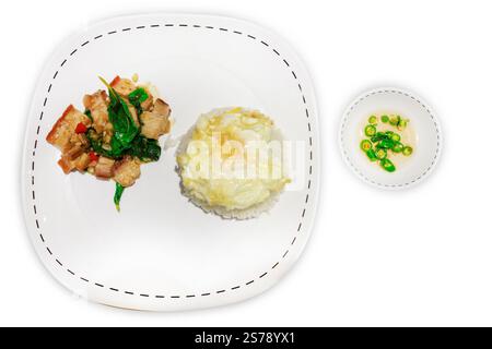 Die cut of Stir Fried Spicy Crispy Pork with Basil On Rice and Fried Egg on white isolated. Stock Photo