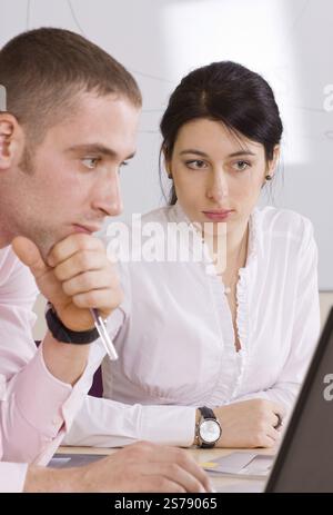 Two young colleagues working together on the computer, Moscow, Russian Federation Stock Photo