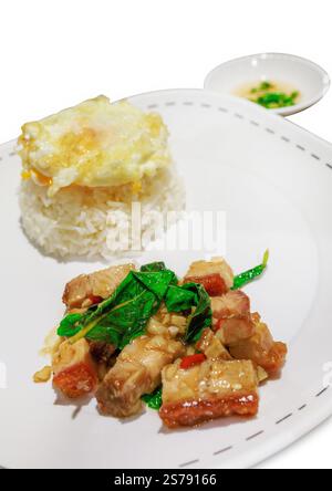 Die cut of Stir Fried Spicy Crispy Pork with Basil On Rice and Fried Egg on white isolated. Stock Photo