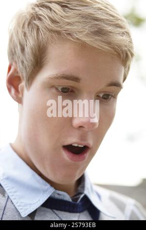 Portrait of a young, handsome, blond man who is surprised by something, Belgium, Europe Stock Photo