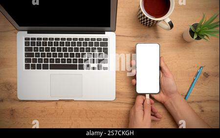 Smartphone mockup, empty, white screen on desk, top view Stock Photo