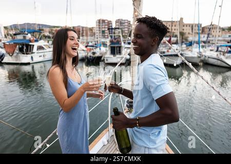 Biracial couple having fun while drinking champagne at party eve Stock Photo