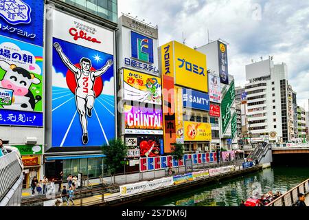 Osaka, Japan- Oct24 , 2024 : Shopping area at Dotonbori at evening of the famous Glico Running Man neon show the famous destination in Shinsaibashi Stock Photo