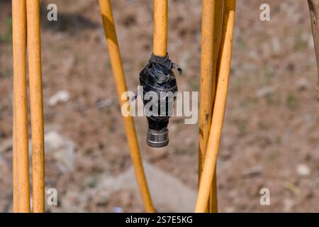A close-up of a puncture air pump filler, showing the black tape wrapped around the handle and the metal nozzle. This essential tool is used to inflat Stock Photo