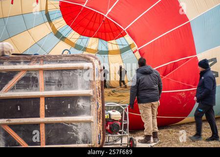 Goreme, Turkey - 27th december, 2024 Hot air balloon inflated and machinery before flight in Cappadocia. Kapadokya balloons flight attraction cancella Stock Photo