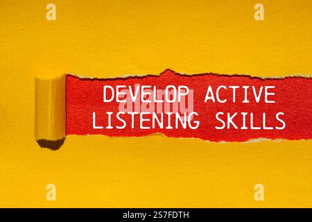 Develop active listening skills message written on ripped torn yellow ...