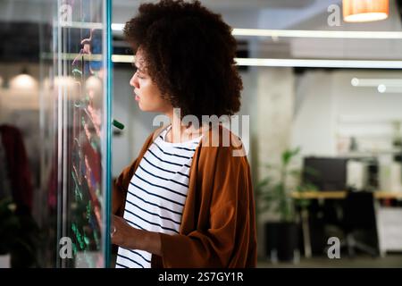 Portrait of african american female IT developer, programmer, designer working with programming code Stock Photo