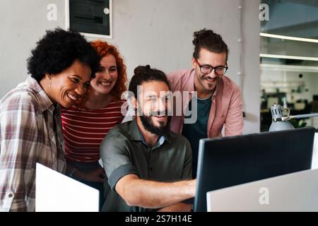 Mixed team of software engineers brainstorming ideas. Diverse app developers collaborating as group Stock Photo