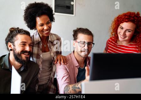 Mixed team of software engineers brainstorming ideas. Diverse app developers collaborating as group Stock Photo