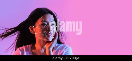Woman showcases facial recognition tech against an abstract background Stock Photo