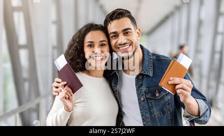 Happy Arab Couple With Passport And Tickets Demonstrating Smartphone ...