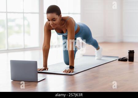 Sporty Woman Doing Cross Body Mountain Climbers Exercise Stock Photo