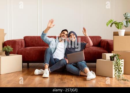 Happy man and woman using laptop after relocation Stock Photo