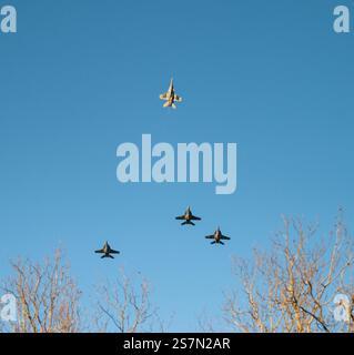 Photo of one white airforce plane pulling away as part of the missing man formation, an aerial salute performed as part of President Carter's flyover. Stock Photo