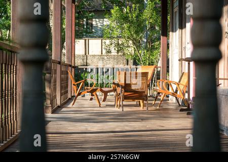 Wooden chairs and table on a house balcony. Holiday or vacation concept. Stock Photo
