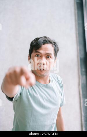 Man pointing with a serious expression. Stock Photo