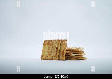 Stack of Salty Crackers Isolated on a Plain White Background Stock Photo