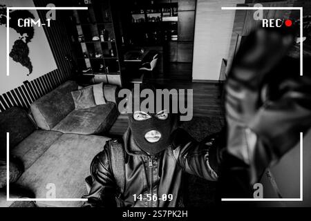 Housebreaking Concept. Intruder sneaking into house at night, holding crowbar, top view from above camera, high angle. The robber noticed a security c Stock Photo