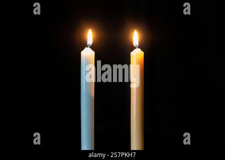 Two big burning candles. Bright light on dark background. Birthday party. Romantic evening on Valentine. RIP darkness template. mourn Stock Photo