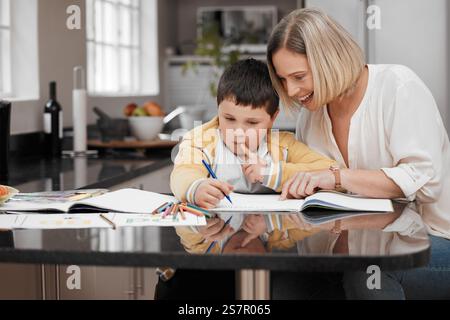 Mother, child or helping with homework in home for learning support, creative development or school project. Education, woman or books with boy Stock Photo