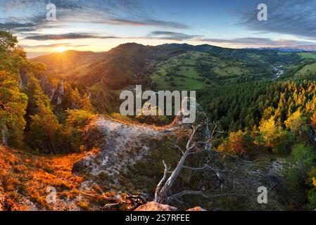 Panoramic view of mountain range under colorful blue and orange sundown in Slovakia. Rocky forest landscape Stock Photo
