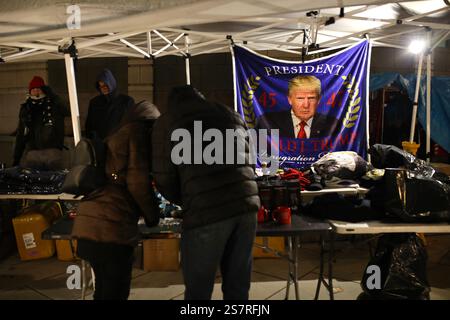 Trump supporters buy Donald Trump goodies at a stand set up in front of the Capitol in Washington, United States, on the eve before Inauguration Day. After his election over Democratic candidate Kamala Harris on November 5, Donald Trump will be inaugurated on Monday, January 20. He will become the 47th President of the United States. The inauguration ceremony will place inside the US Capitol, due to a cold snap. The last time an indoor ceremony was held was in 1985. (Photo by Apolline Guillerot-Malick/SOPA Images/Sipa USA) Stock Photo