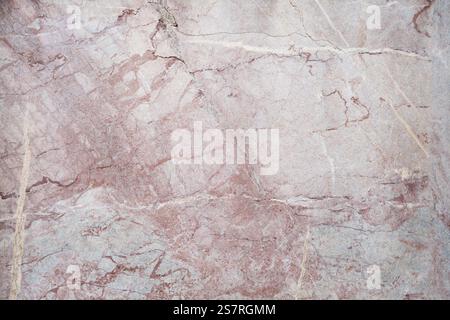 A detailed closeup of beige marble texture with visible cracks and veins creating an organic pattern Stock Photo