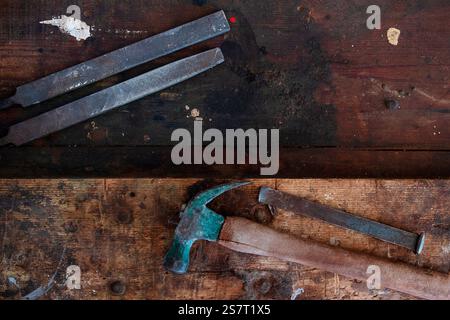 Old grungy and dirty wooden workbench with woodworking tools on it. Shot in natural light. Stock Photo