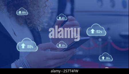 Image of clouds with percents and arrows over caucasian businesswoman using smartphone Stock Photo