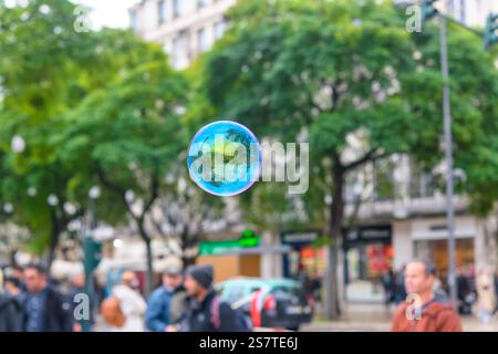 A soap bubble floats in a town square during a protest against the Islamic Republic of Iran, created by someone not associated with the protest. Stock Photo