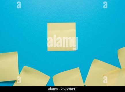 blank yellow sticky note on a blue background Stock Photo