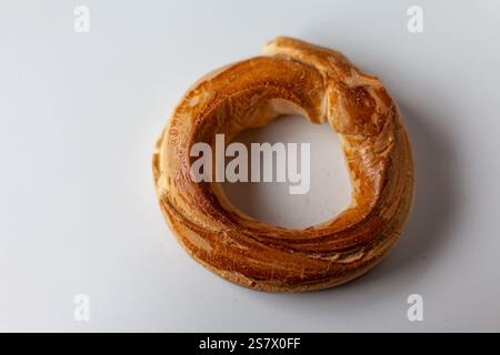 Homemade doughnut with butter and anise, captured in detail on a white background, ideal for traditional bakery themes. Stock Photo