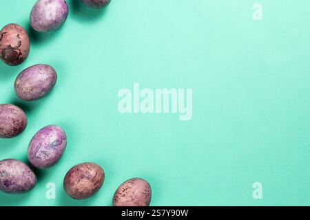 Colorful painted egg frame on light green background. Easter design for greeting card with copy space. Easter eggs top view Stock Photo