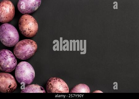 Colorful painted egg frame on black background. Easter design for greeting card with copy space. Easter eggs top view Stock Photo