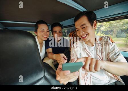 Friends Using GPS During Driving Stock Photo