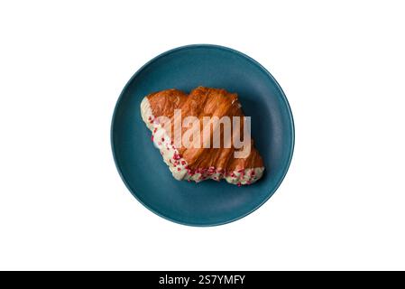 Crispy sweet red croissant with pistachio, raspberry and strawberry on a white background Stock Photo