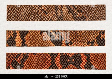 Close-up of snake skin texture pattern on leather strips. Design features beautiful brown and orange color combination resembling snake's scales Stock Photo