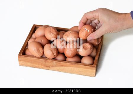 Wooden tray with cracked eggs Stock Photo
