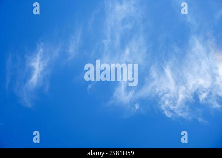 big blue sky with sunlit clouds in horizontal position Stock Photo